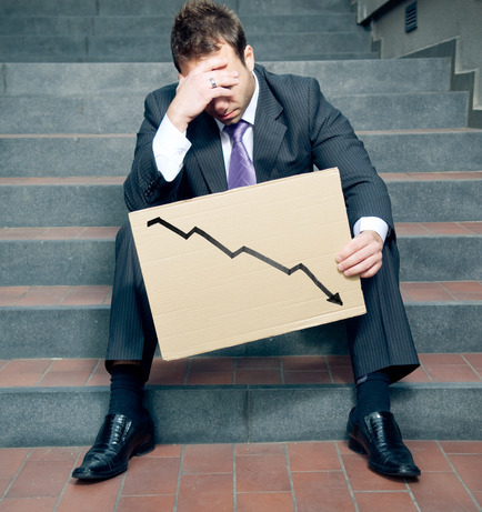 Desperate businessman showing negative graph